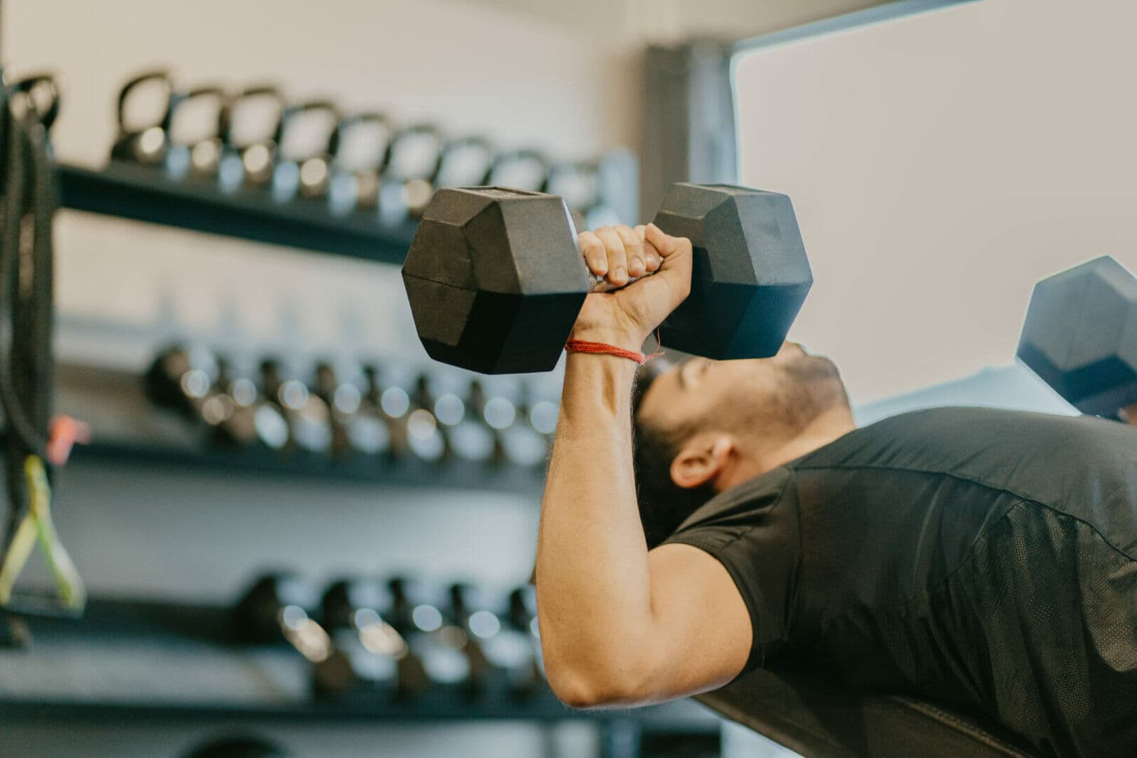 A coach spotting a client during a personal training session